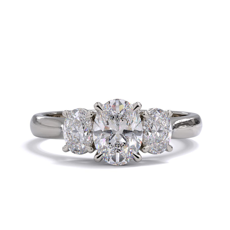 A three stone diamond engagement ring with oval diamonds set in platinum or white gold.
