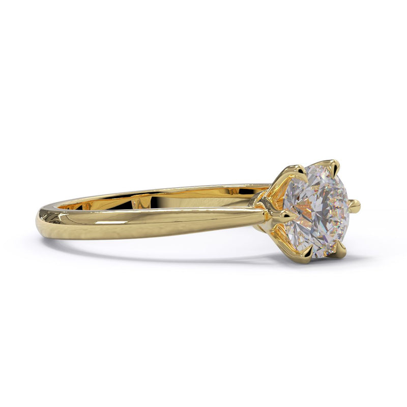 A single round diamond ring with a round cut stone set in a gold band.