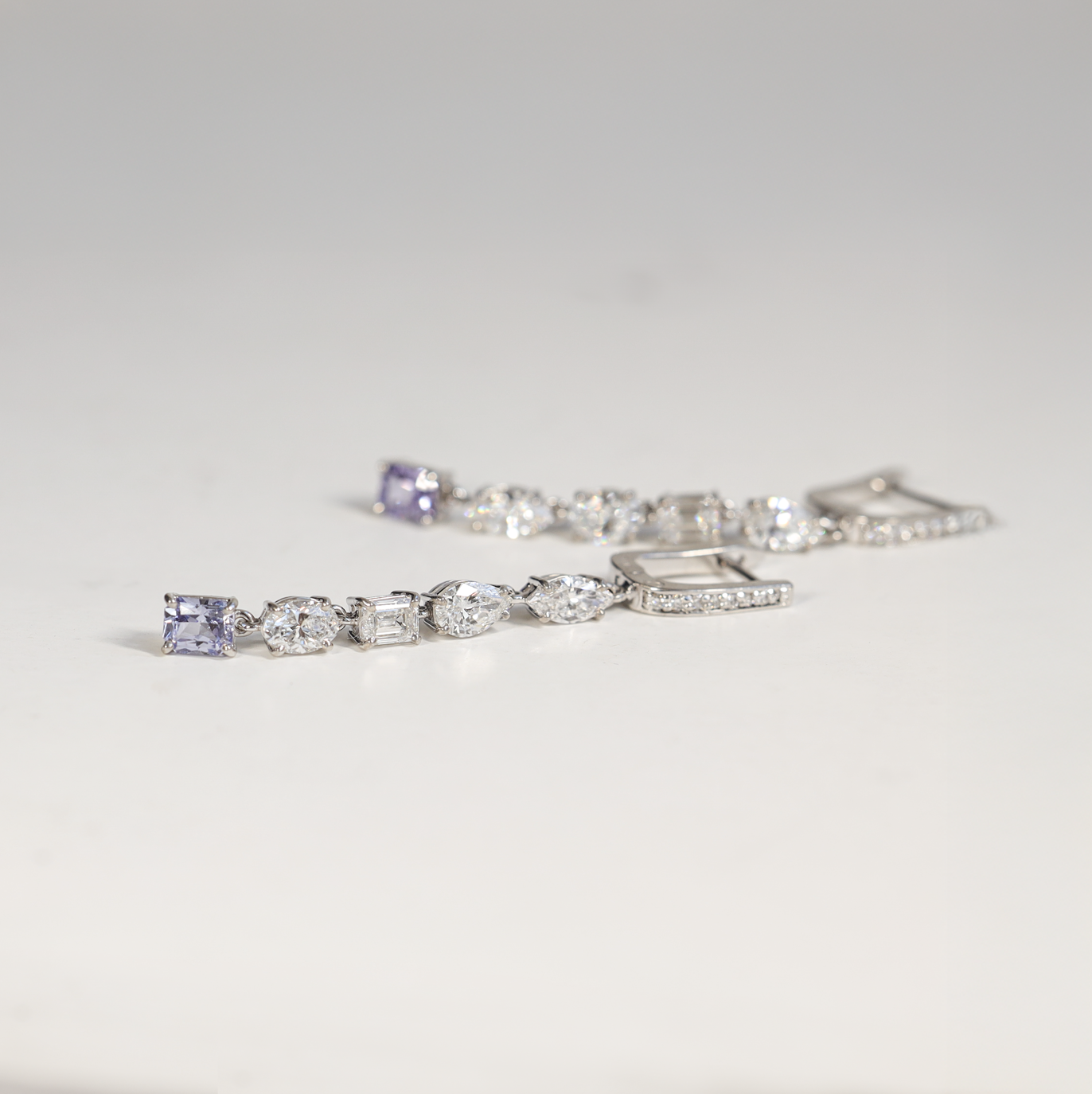 Diamond Drop Earrings with different shaped diamonds. Purple diamond. Made by our Master Jeweller