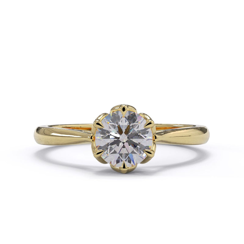 A round diamond ring with a gold band and floral-style setting.