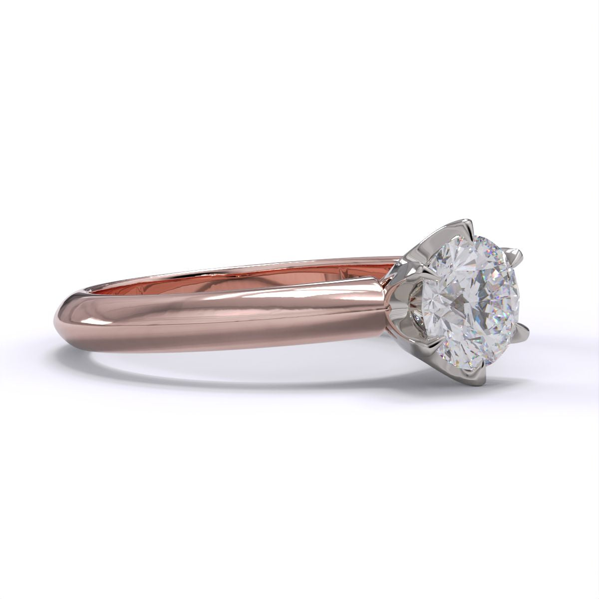 A rose gold band solitaire ring with a round diamond.