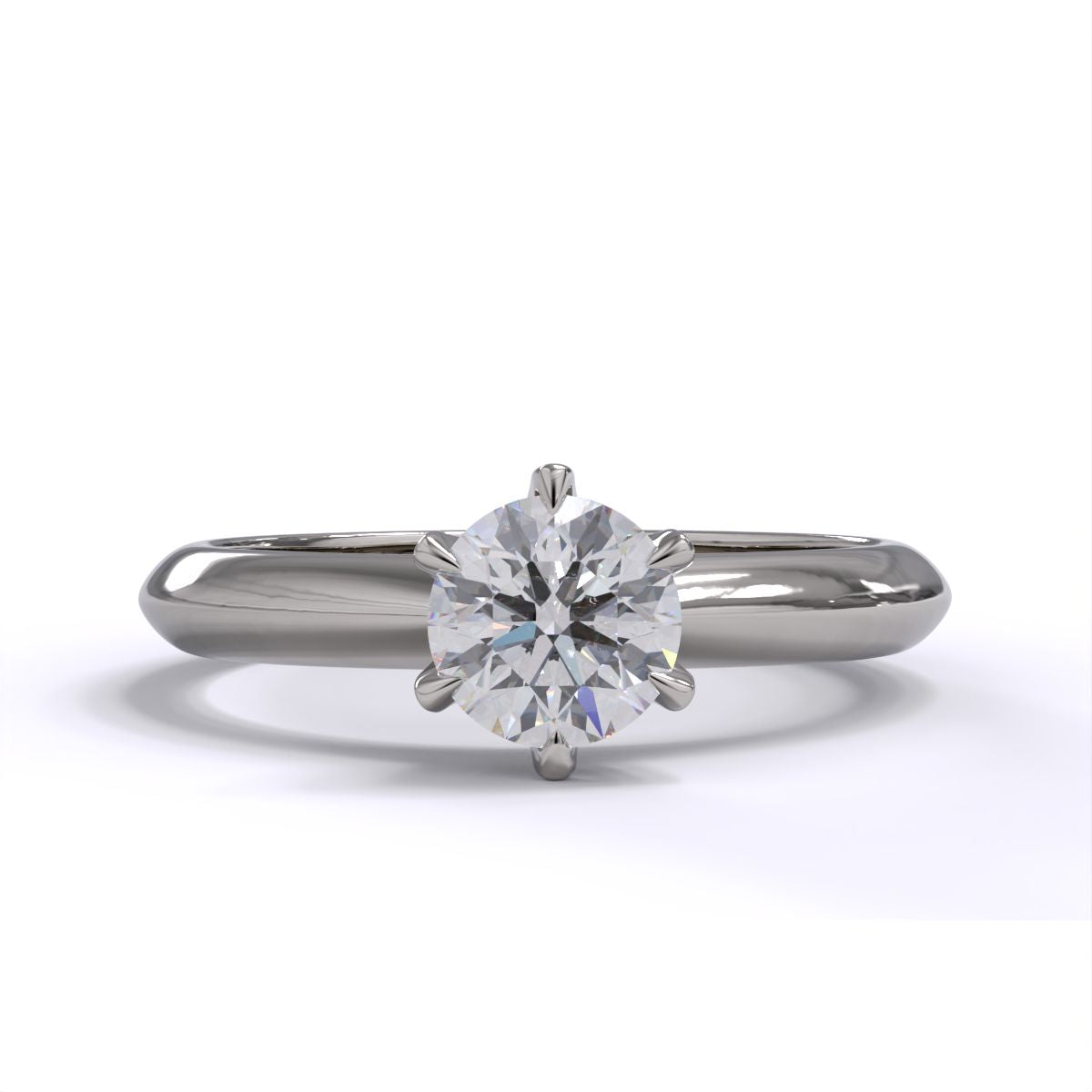 A platinum or whiet gold band solitaire ring with a round diamond.