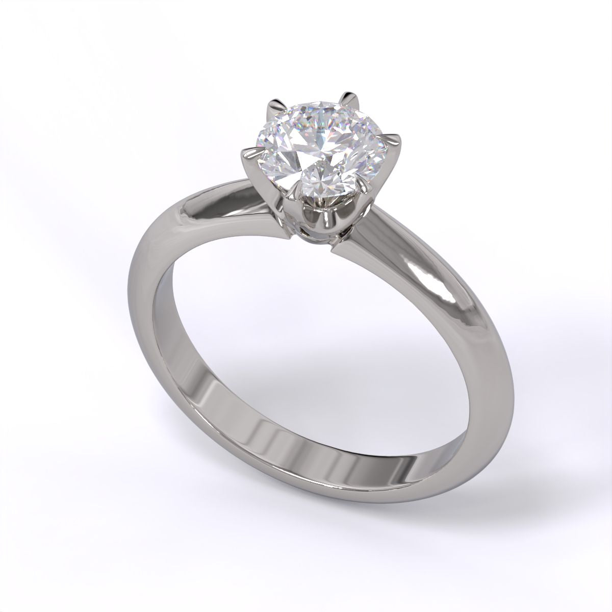A platinum or whiet gold band solitaire ring with a round diamond.