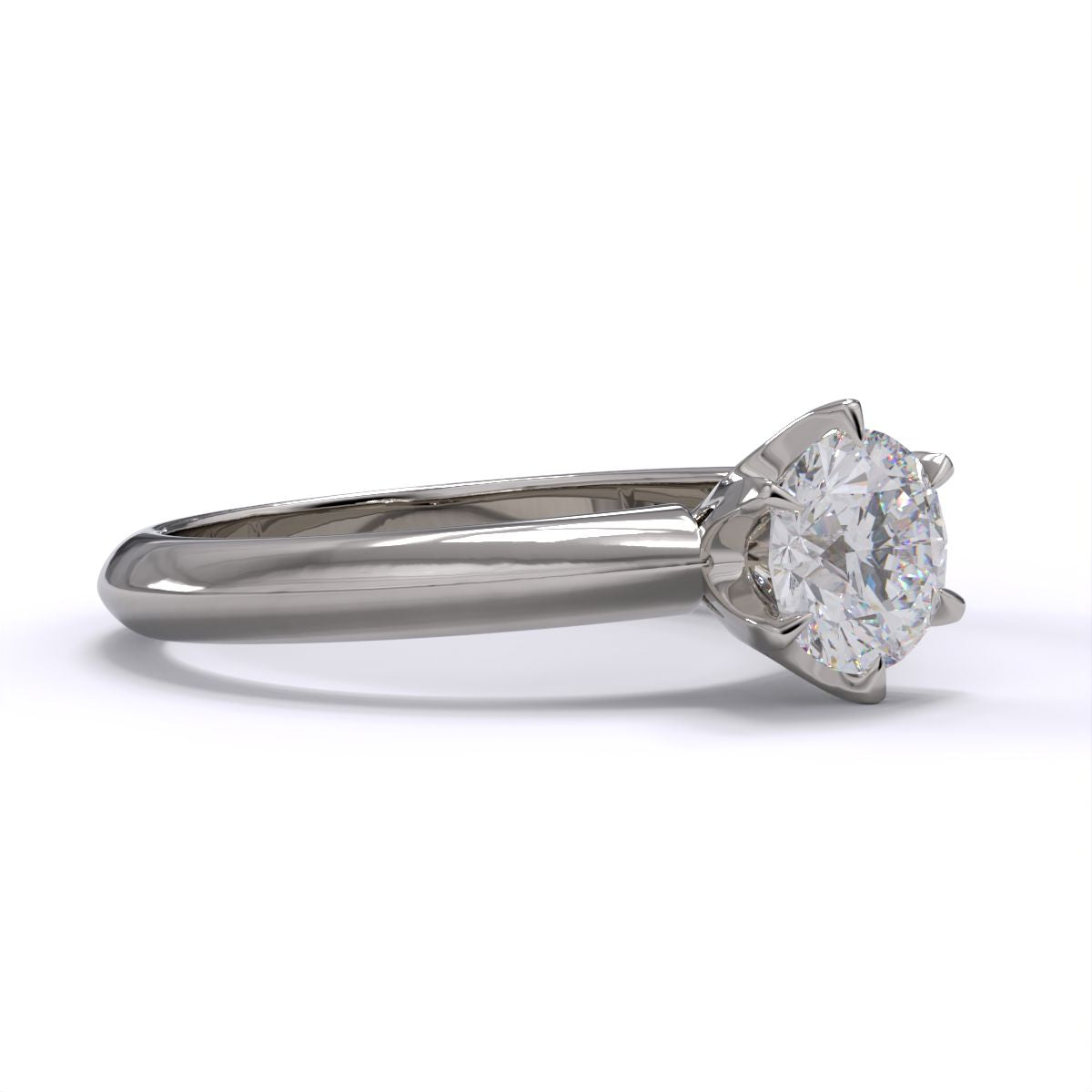 A platinum or whiet gold band solitaire ring with a round diamond.