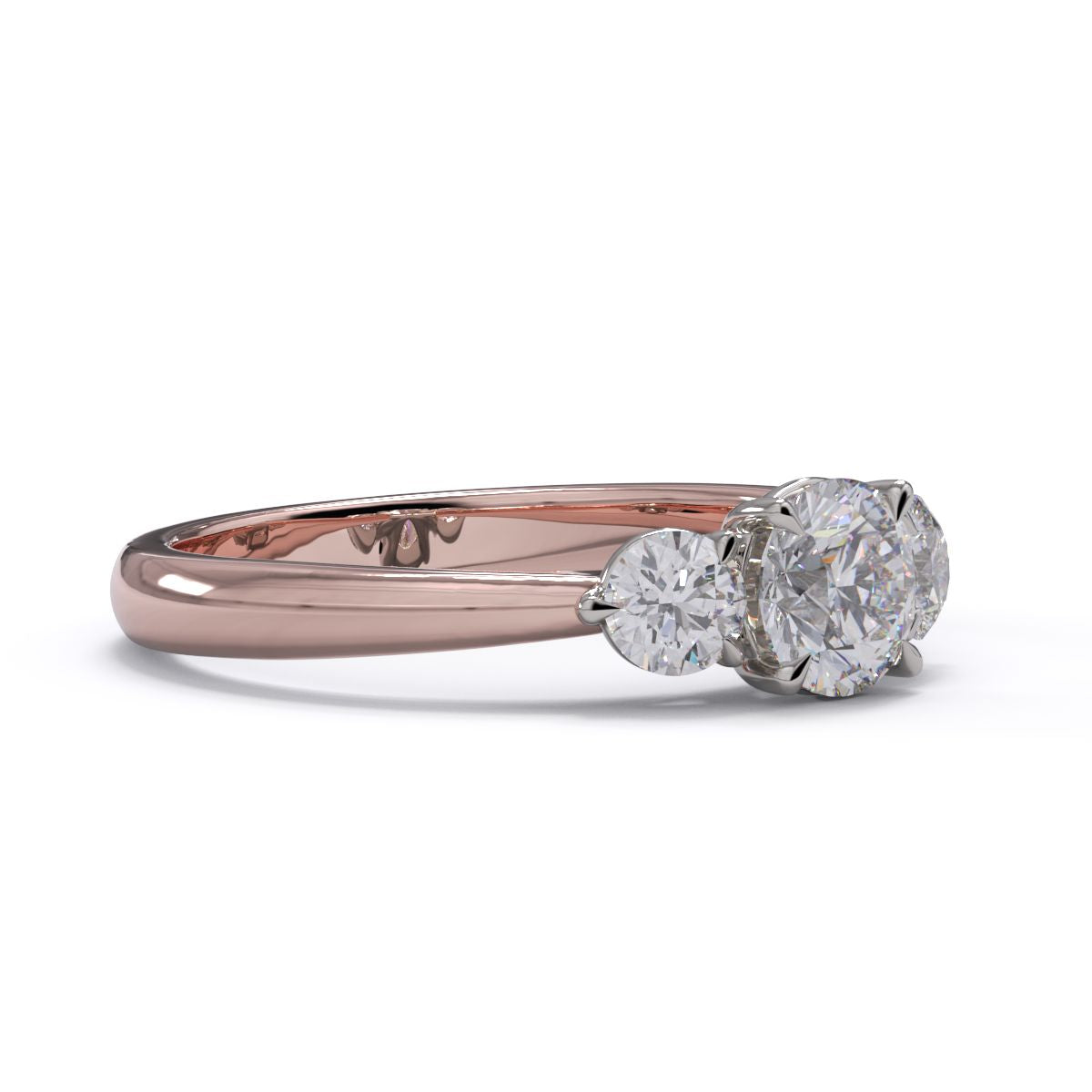 A three-stone diamond engagement ring with a rose gold band and platinum setting.