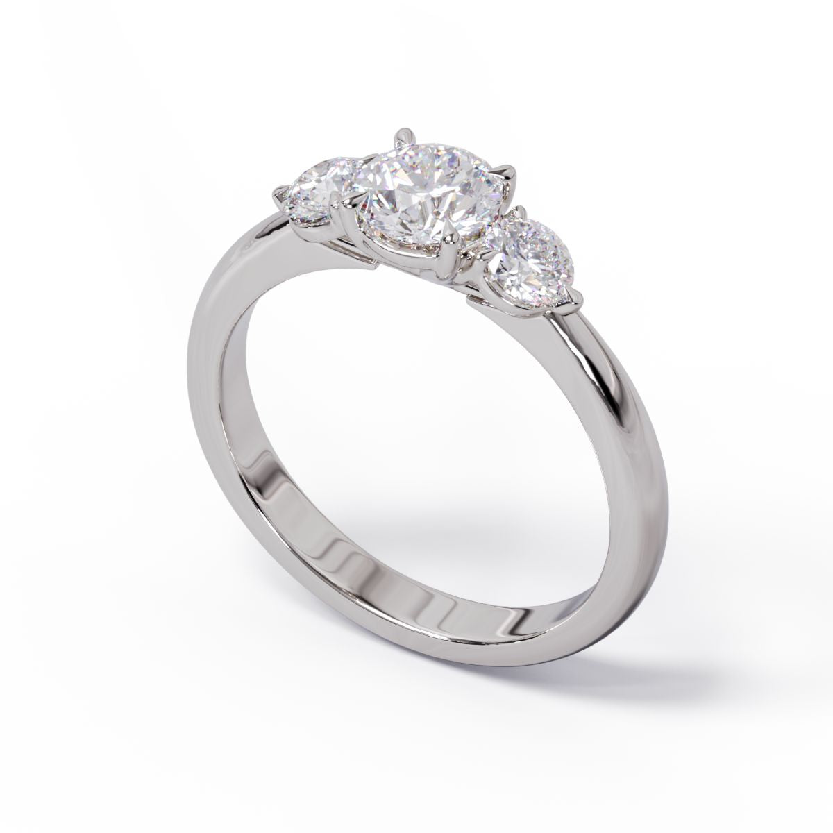 A three-stone diamond engagement ring with a platinum or white gold band and platinum setting.