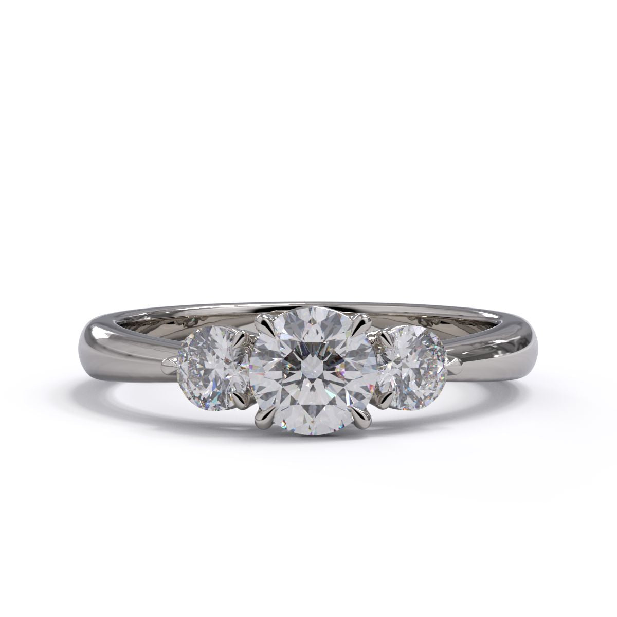 A three-stone diamond engagement ring with a platinum or white gold band and platinum setting.