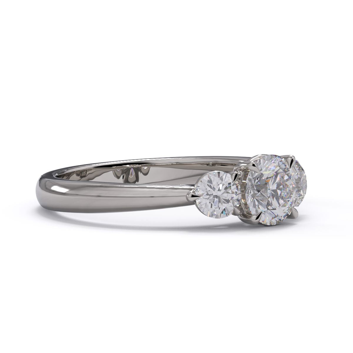 A three-stone diamond engagement ring with a platinum or white gold band and platinum setting.