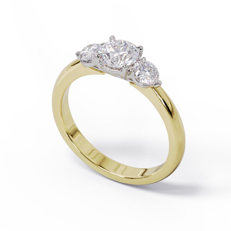 A three-stone diamond engagement ring with a yellow gold band and platinum setting.