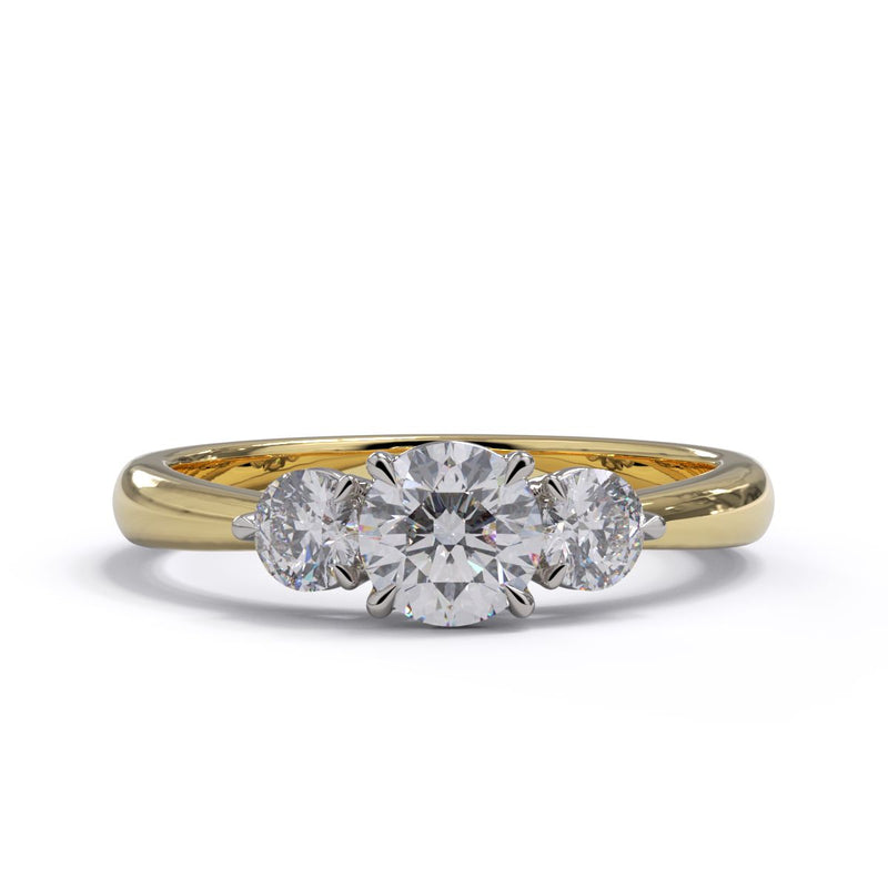A three-stone diamond engagement ring with a yellow gold band and platinum setting.