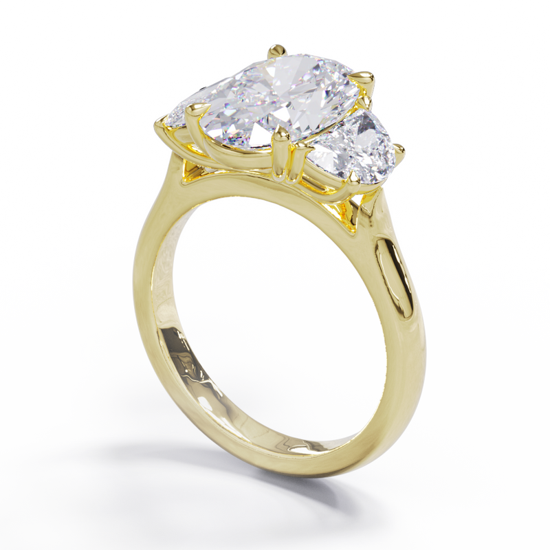 An exquisite white diamond engagement ring with an oval centerpiece flanked by two half moon diamonds, set in a gold band