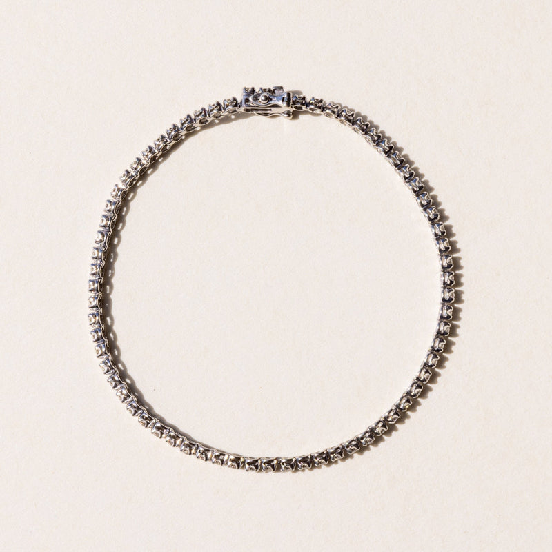 A tennis bracelet and adorned with round brilliant cut diamonds.
