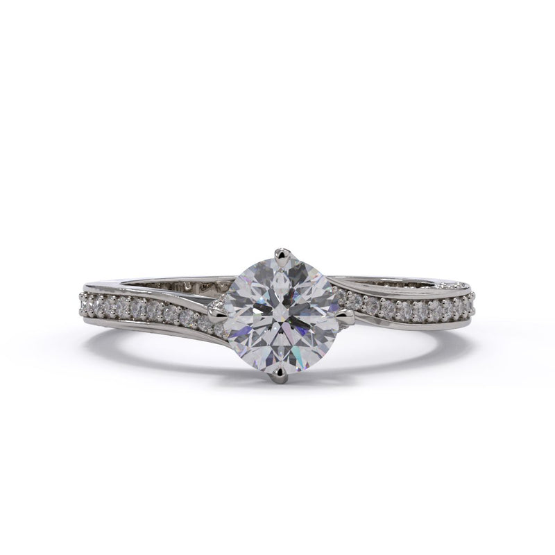 A round diamond twist ring with smaller diamonds on the band, set in white gold.