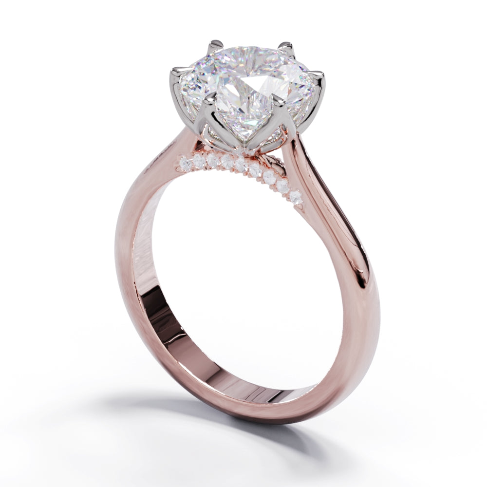 A rose gold ring with a large round diamond and smaller pave diamonds on the band