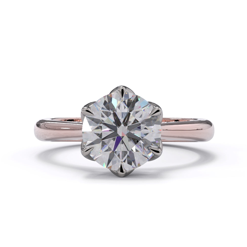 A rose gold ring with a large round diamond and smaller pave diamonds on the band