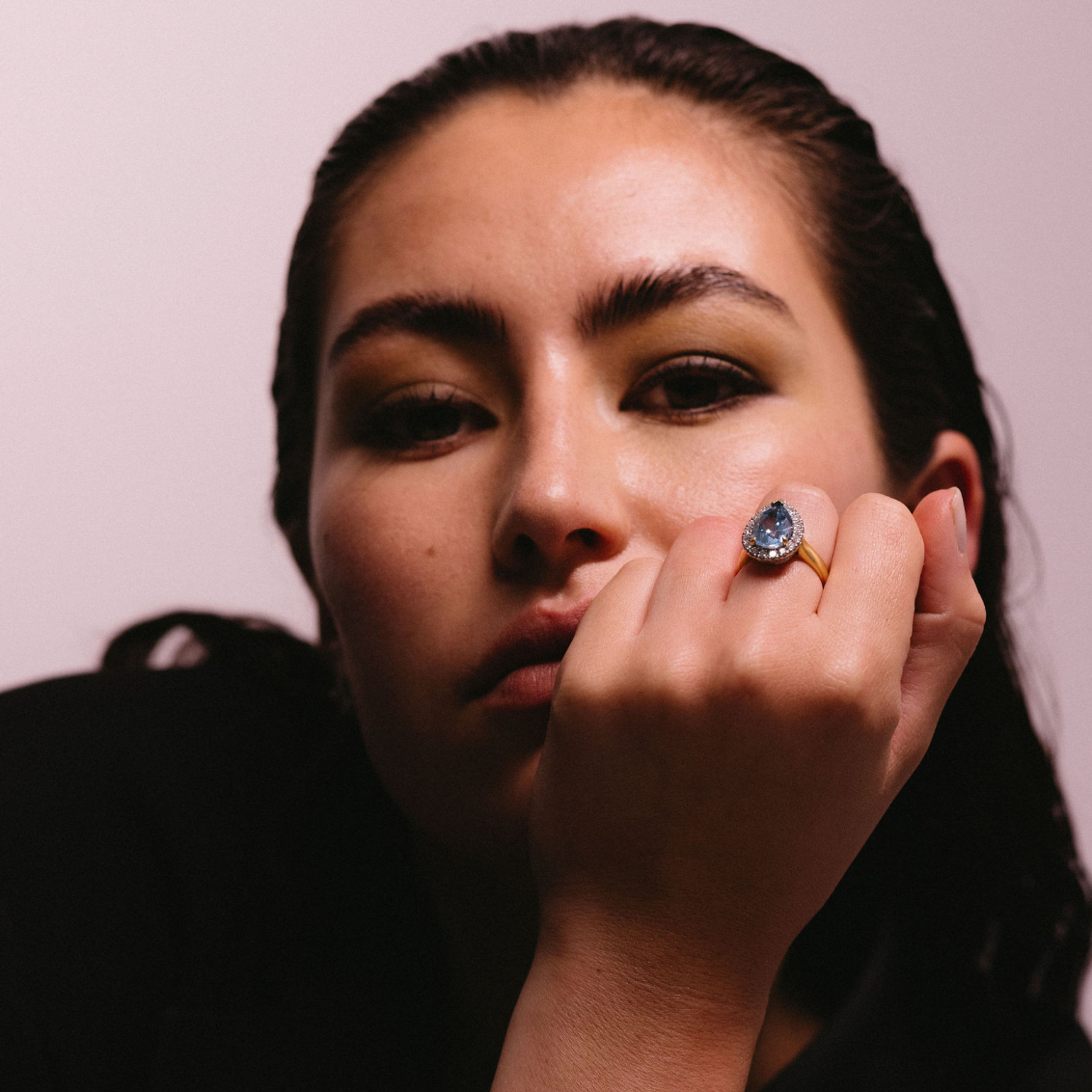 female model wears Unique Aquamarine Cocktail Ring in 18ct Yellow Gold handmade by our Master Jeweller