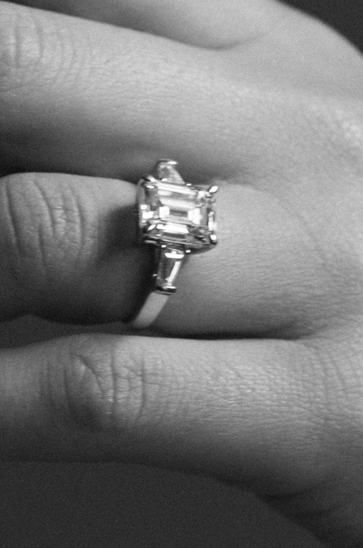 Close-up of a diamond emerald cut ring on a hand
