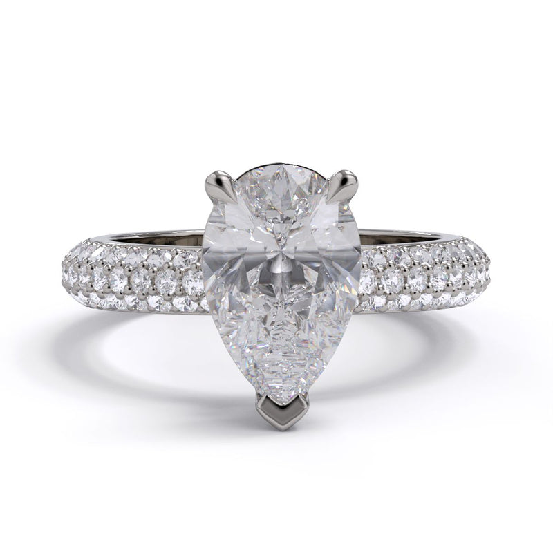 An elegant engagement ring featuring a pear cut diamond center stone with a pavé band.