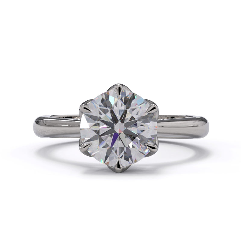A white gold or platinum ring with a large round diamond and smaller pave diamonds on the band