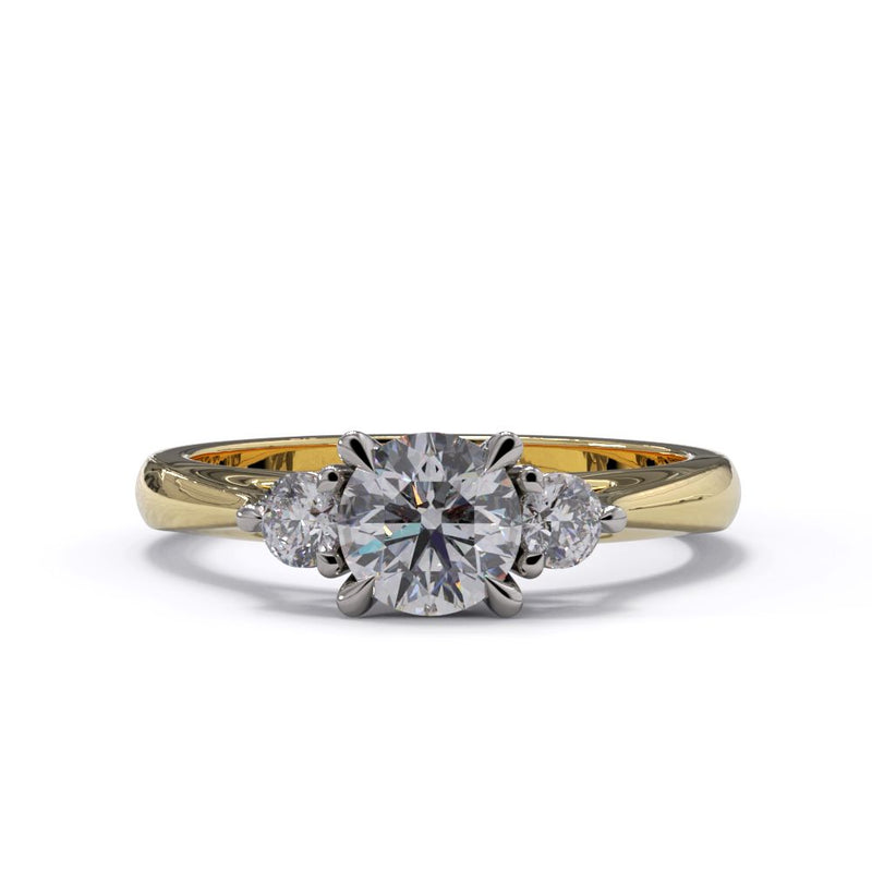 A three-stone diamond engagement ring with a central larger diamond flanked by two smaller diamonds, set in a yellow gold band.