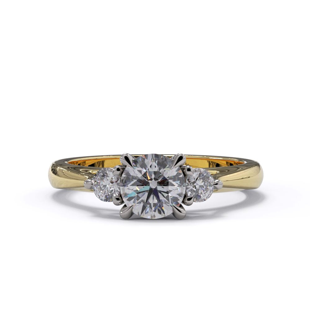 A three-stone diamond engagement ring with a central larger diamond flanked by two smaller diamonds, set in a yellow gold band.