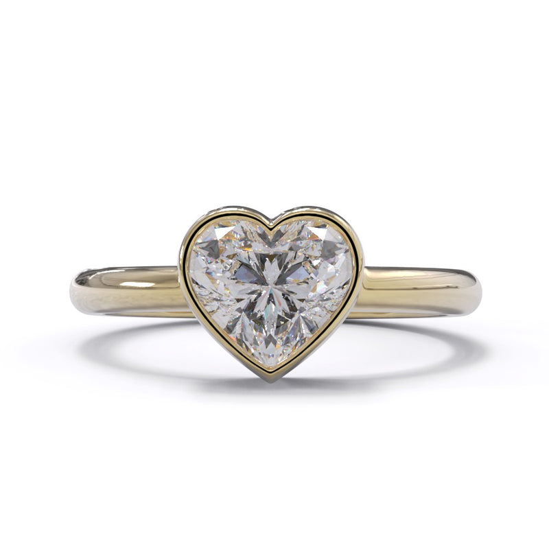 A heart-shaped diamond ring with a yellow gold band and a Solitaire setting.