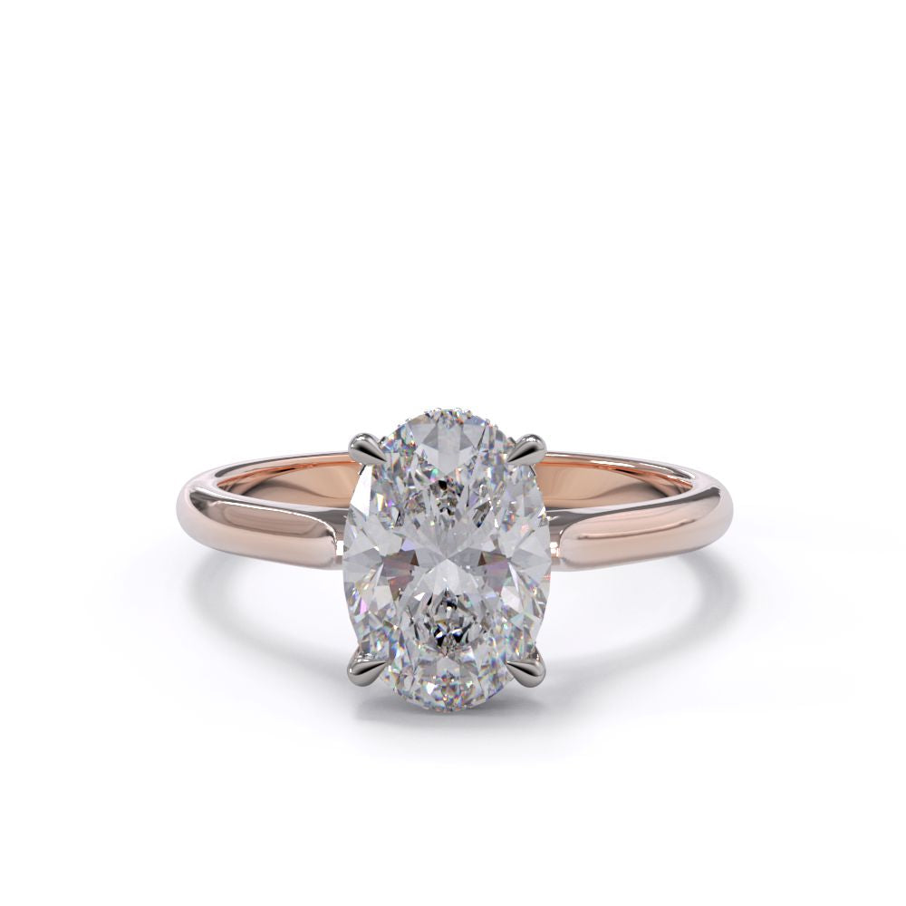 An oval solitare engagement ring with a halo of round pave diamond. Set in a platinum setting on a rose gold or platinum band.