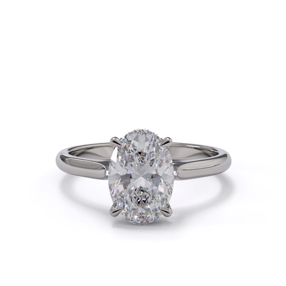 An oval solitare engagement ring with a halo of round pave diamond. Set in a platinum setting on a white gold or platinum band.