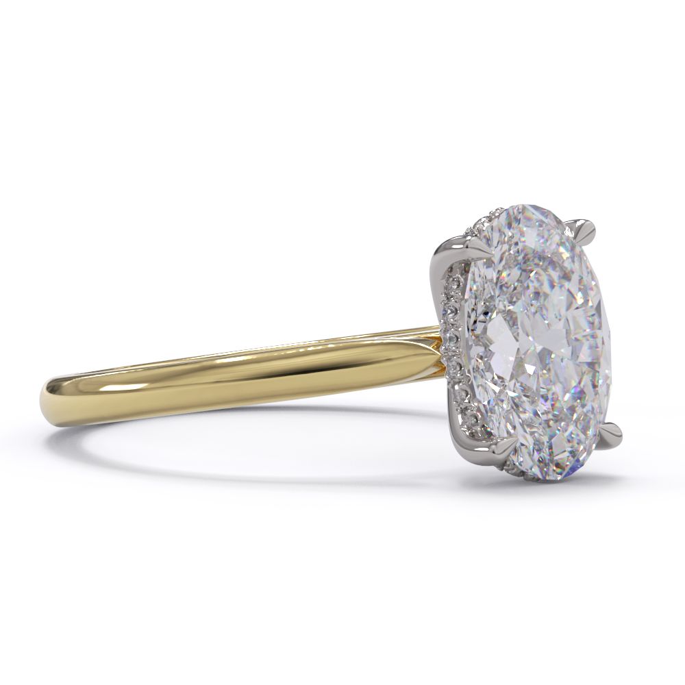 An oval solitare engagement ring with a halo of round pave diamond. Set in a platinum setting on a yellow gold band.