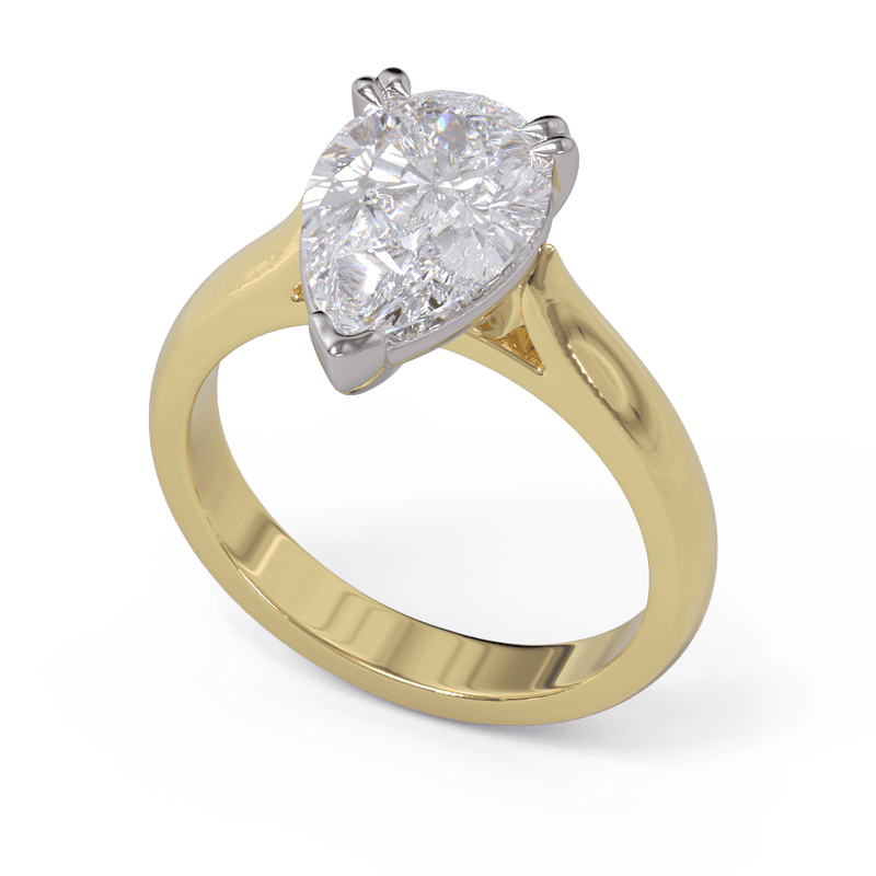 A pear-cut diamond solitaire ring with a double-claw setting and a yellow gold band.