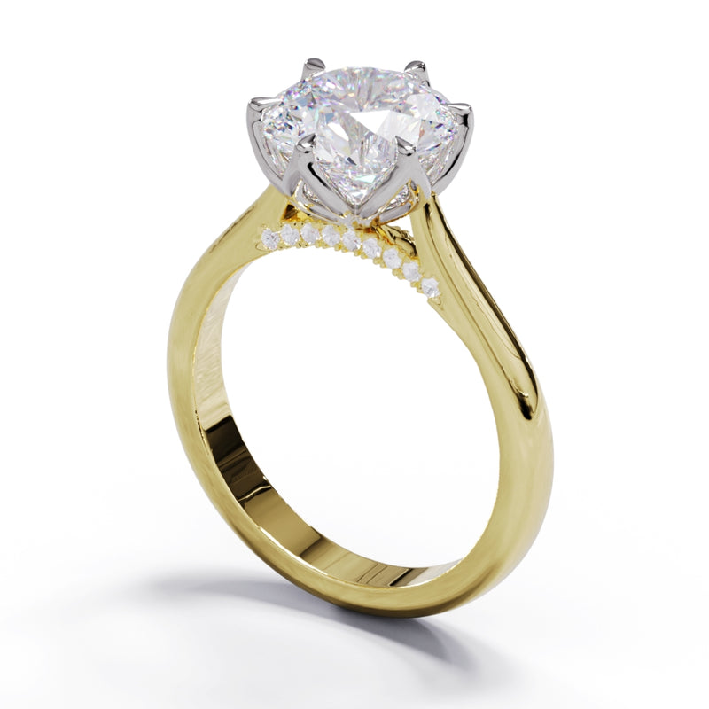 A yellow gold engagement ring with a large round diamond and smaller pave diamonds on the band