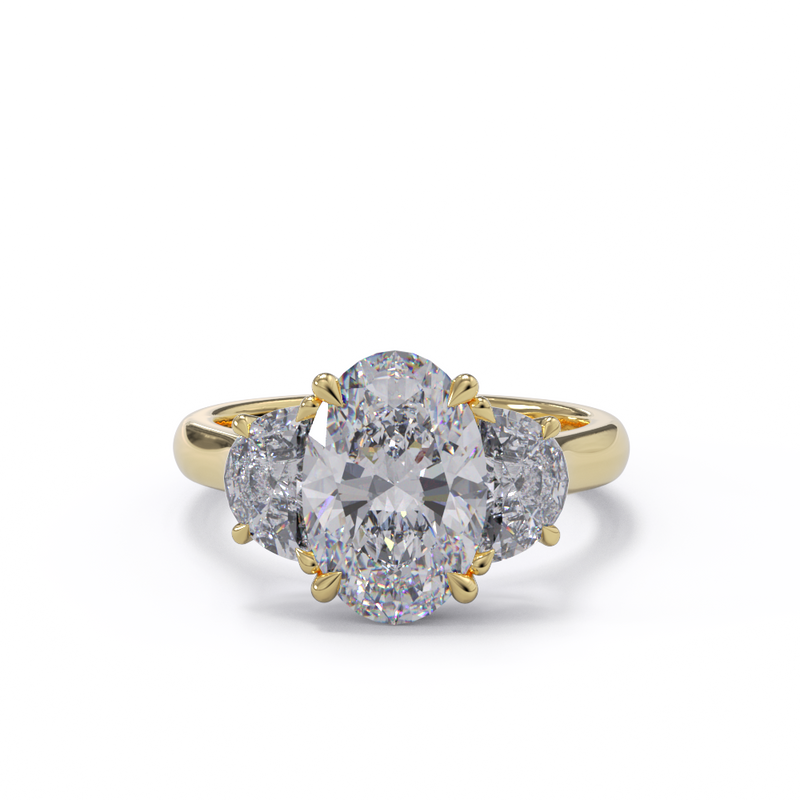 An exquisite yellow gold diamond engagement ring with an oval centerpiece flanked by two half moon diamonds, set in a gold band
