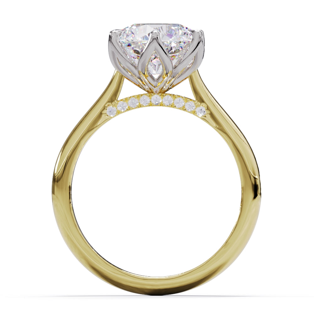 A yellow gold ring with a large round diamond and smaller pave diamonds on the band