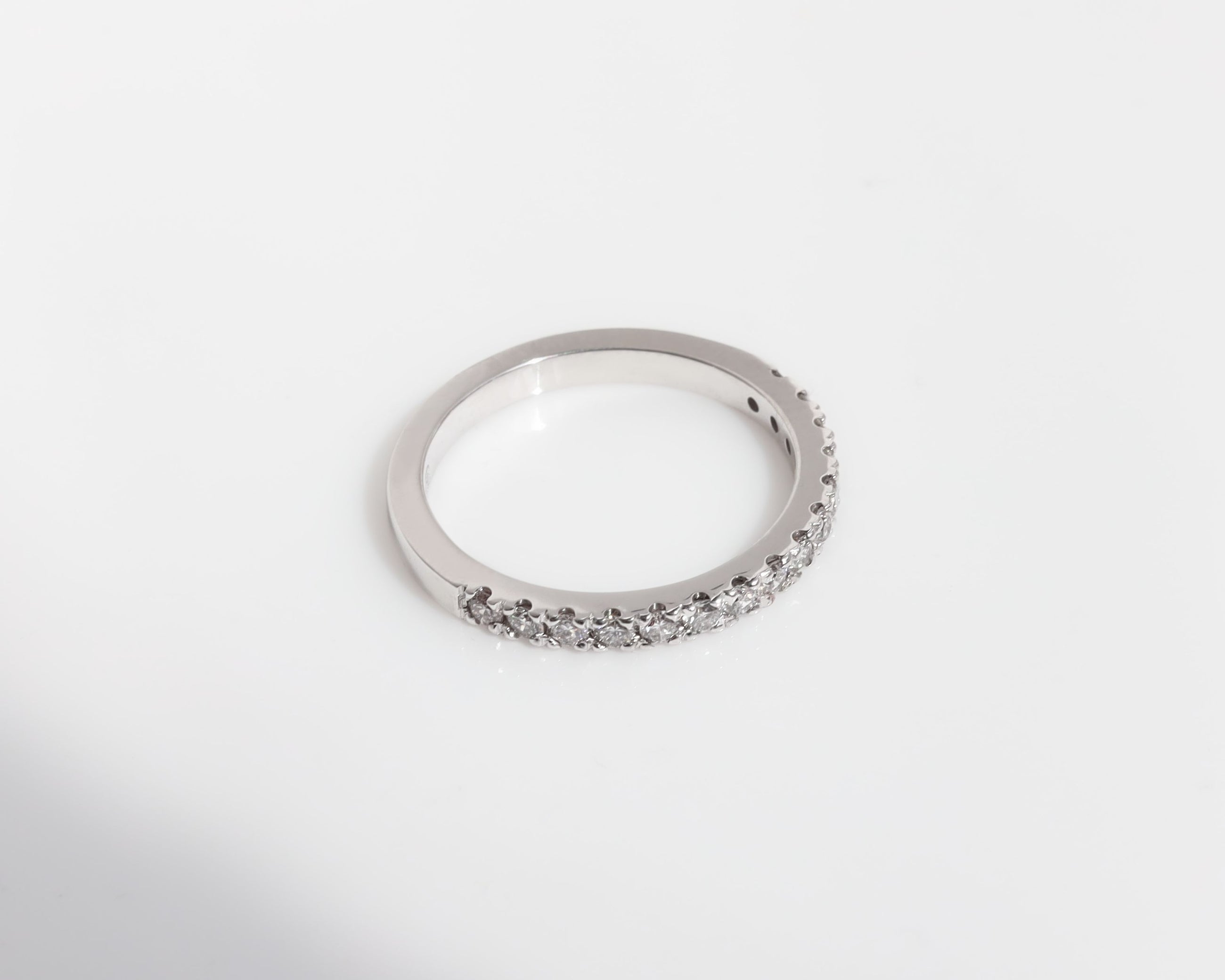 white-gold diamond wedding ring on a white background.