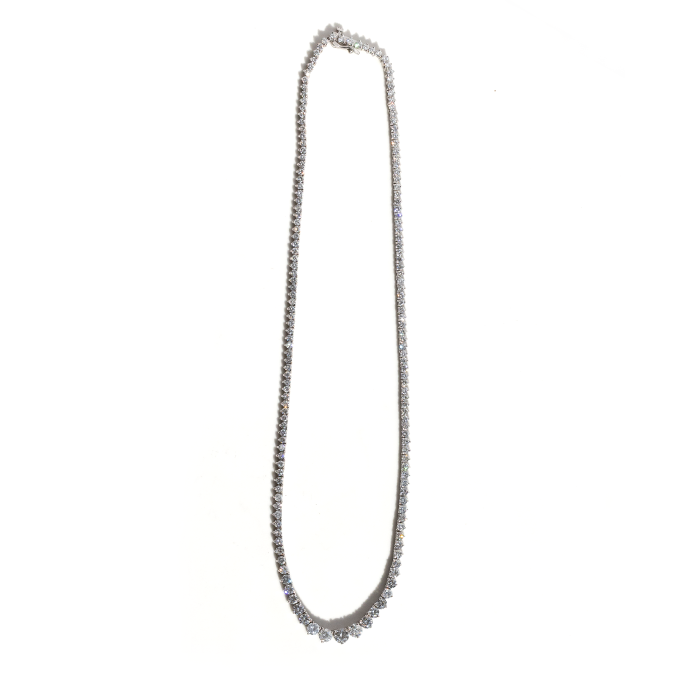 A tennis necklace featuring a row of round-cut diamonds set in white gold, displayed against a white background.