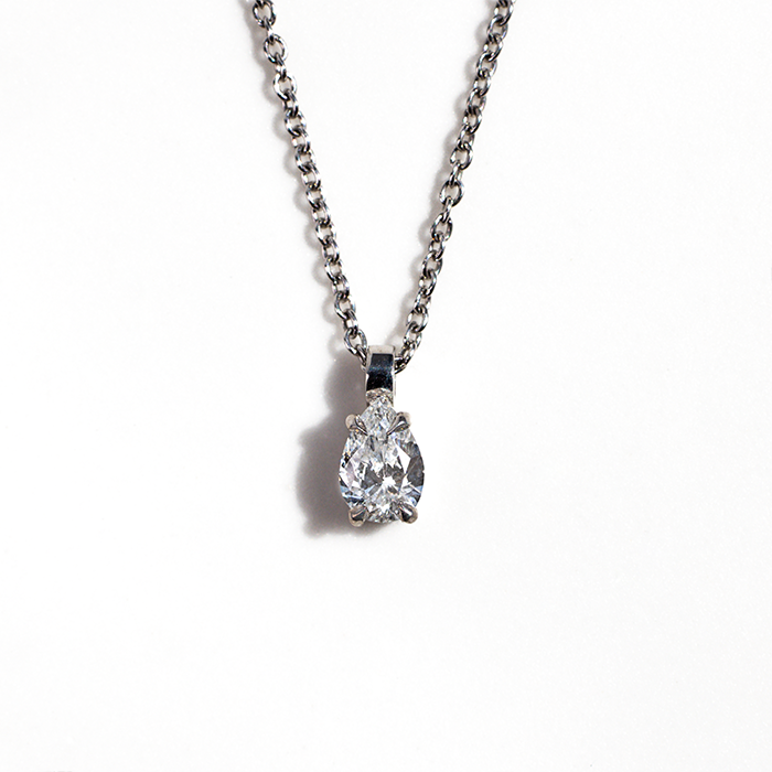 A white gold Hazel Petite Diamond Necklace with a pear-cut diamond pendant.