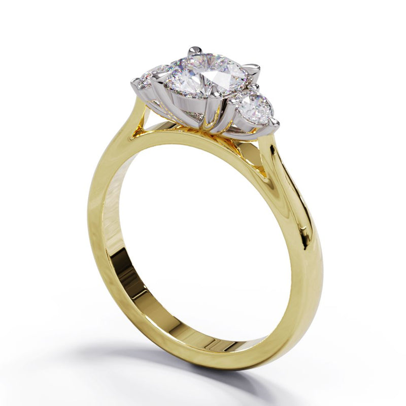A three-stone diamond engagement ring with a central larger diamond flanked by two smaller diamonds, set in a yellow gold band.