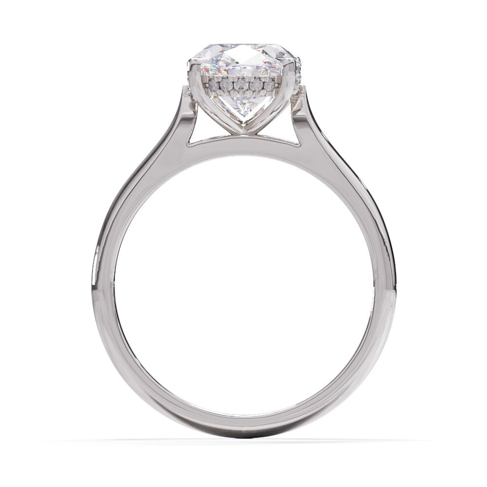 An oval solitare engagement ring with a halo of round pave diamond. Set in a platinum setting on a white gold or platinum band.