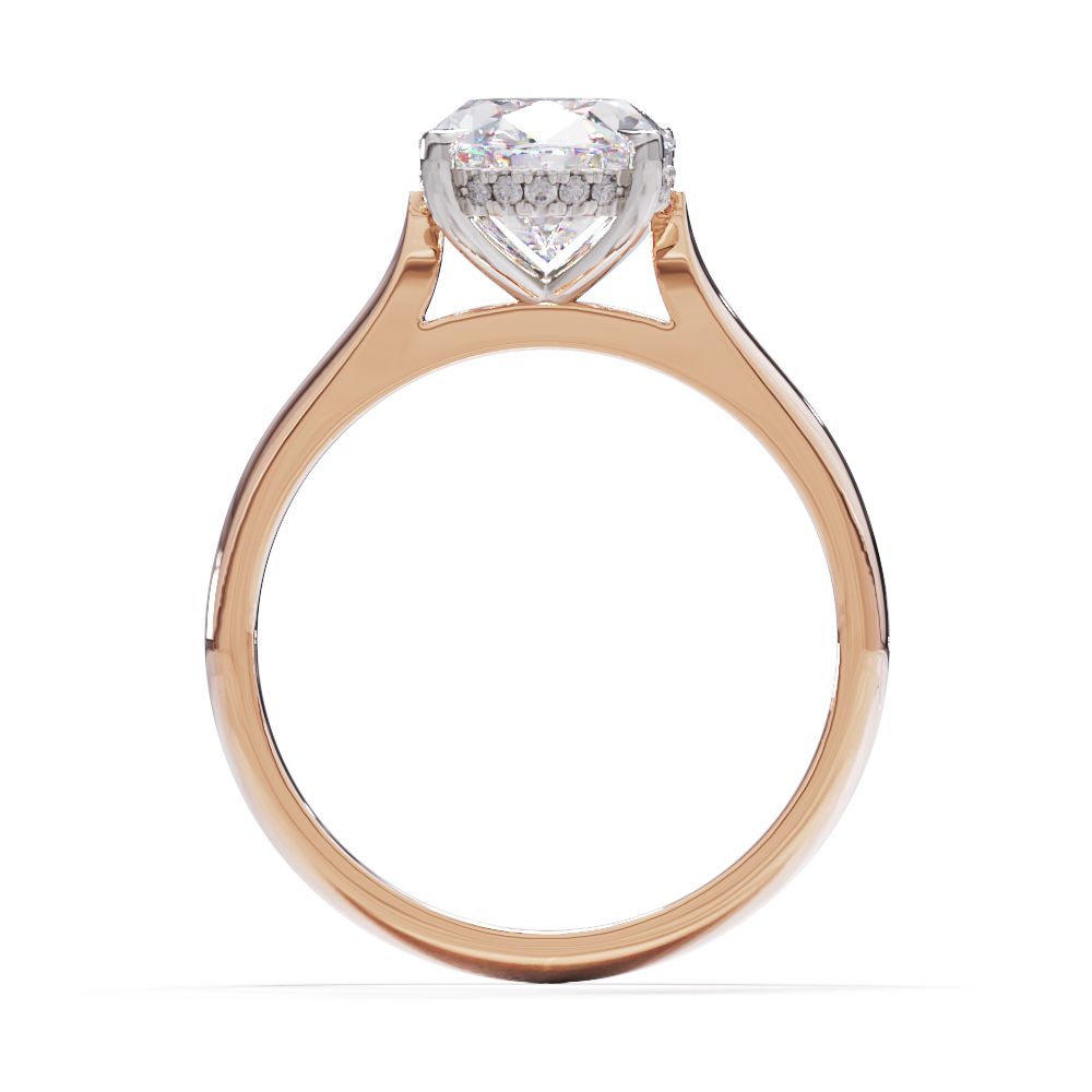 An oval solitare engagement ring with a halo of round pave diamond. Set in a platinum setting on a rose gold or platinum band.