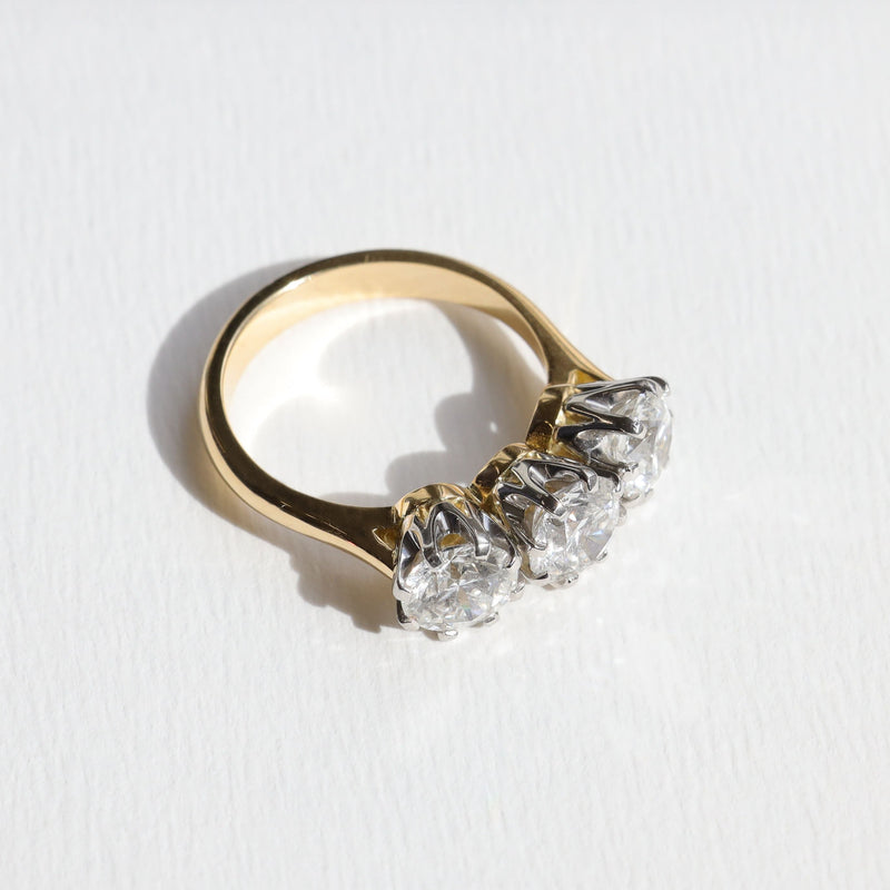 Gold emgagement ring with three diamonds on a white background. Made in Aucjkland, New Zealand.