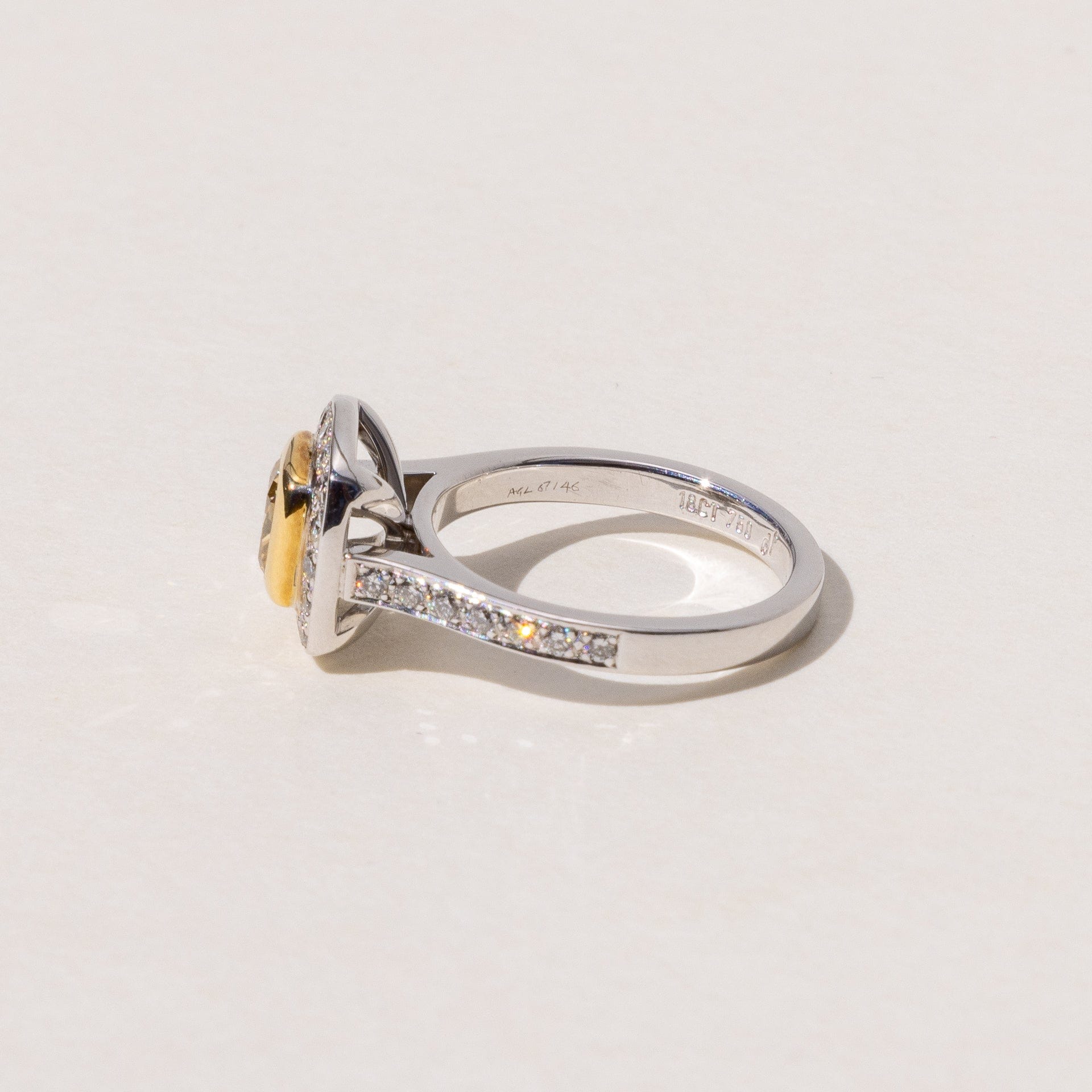 side profile of square solitare engagement ring with pave diamonds down the band