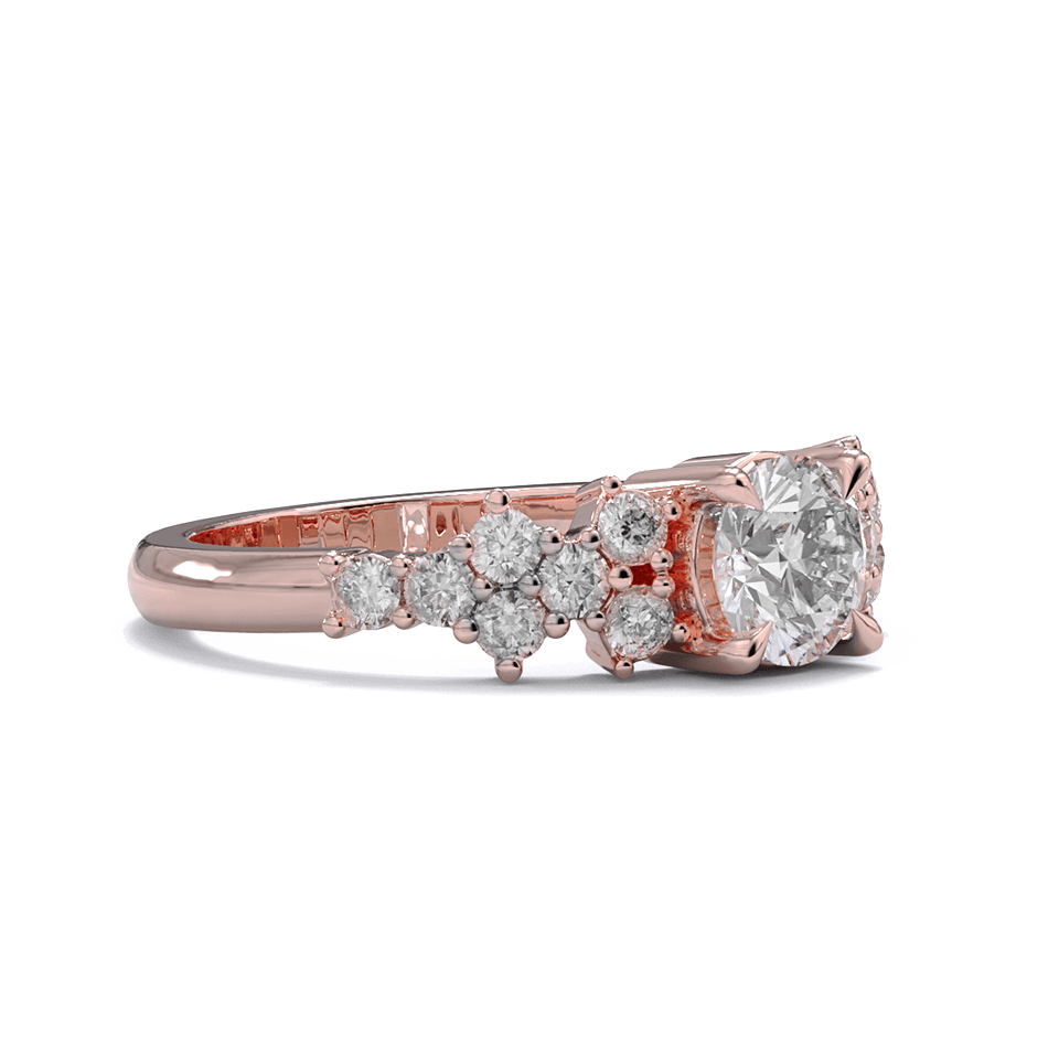A rose gold engagement ring with a round diamond center stone and clusters of round diamonds on each side. Pave diamonds down the side of band.