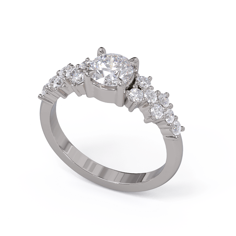 A white gold or platinum engagement ring with a round diamond center stone and clusters of round diamonds on each side. Pave diamonds down the side of band.