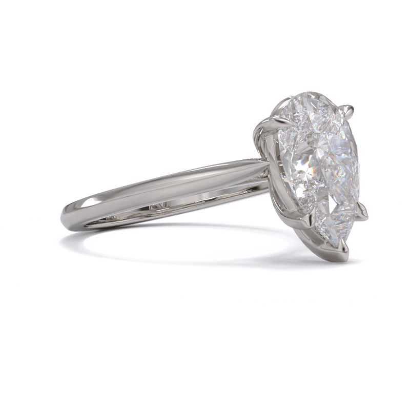 A solitaire ring with a pear-cut diamond center stone held by five-claw platinum or white gold setting