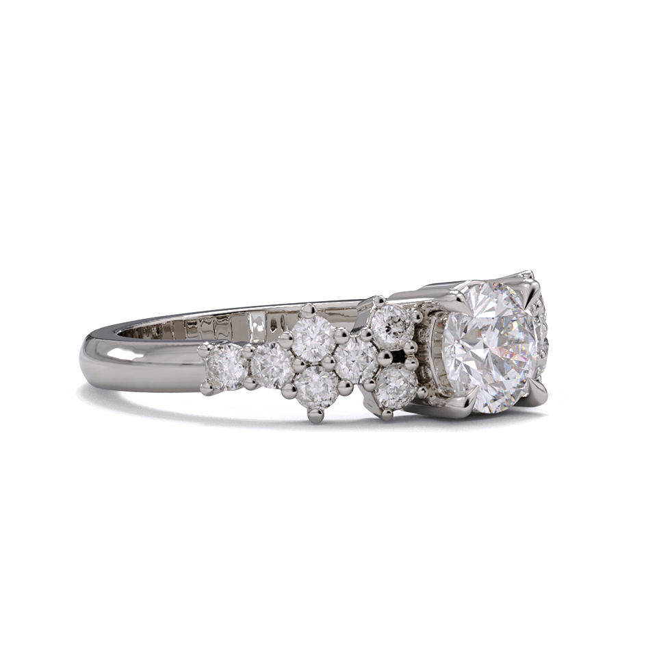 A white gold or platinum ring with a round diamond center stone and clusters of round diamonds on each side. Pave diamonds down the side of band.