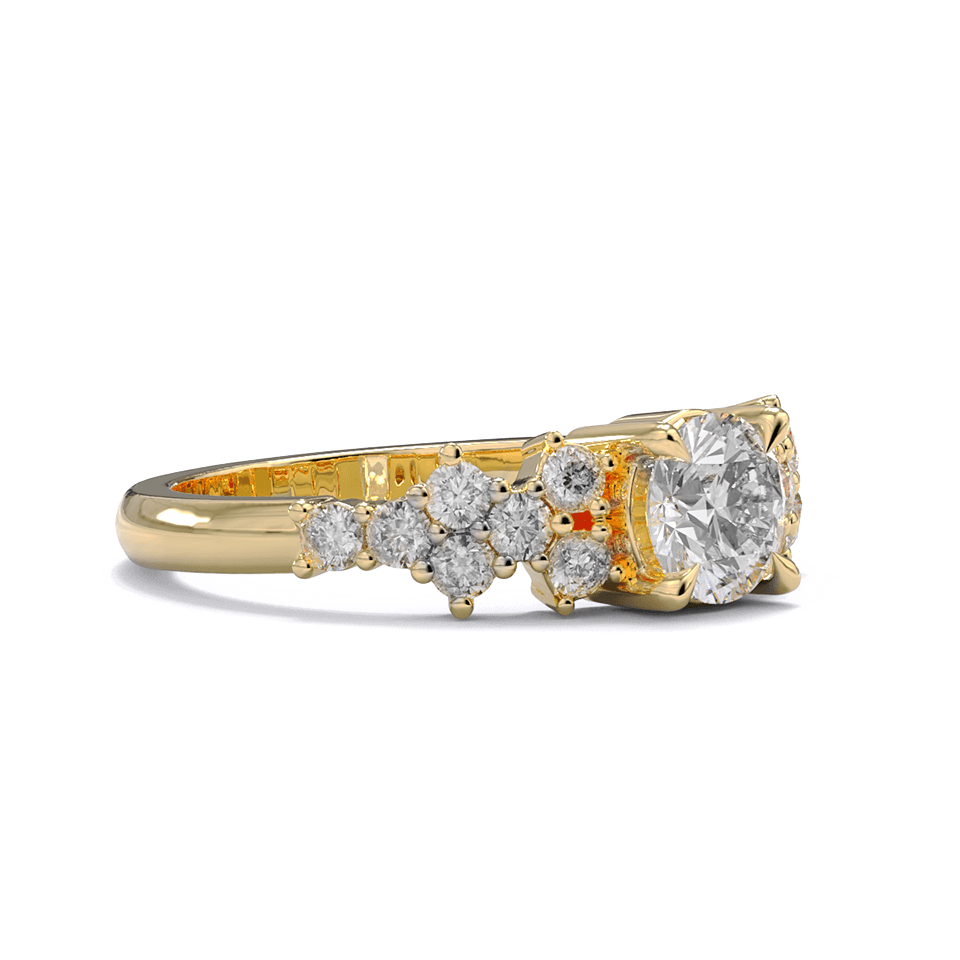 A yellow gold engagement ring with a round diamond center stone and clusters of round diamonds on each side. Pave diamonds down the side of band.