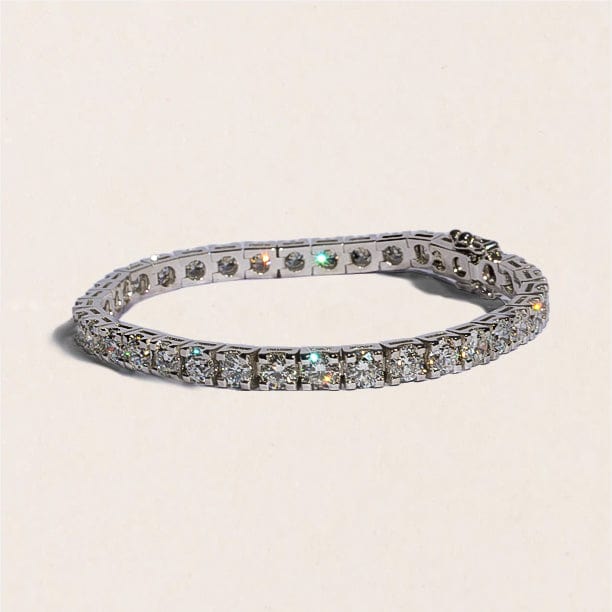 A tennis bracelet featuring a series of round brilliant cut diamonds, set in a white gold band.