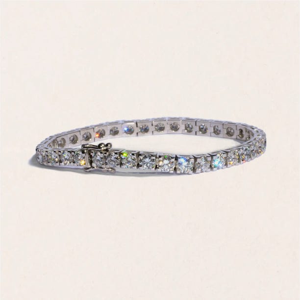 A tennis bracelet featuring a series of round brilliant cut diamonds, set in a white gold band.