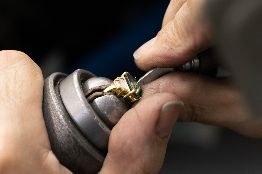 close-up image of emerald engagement ring being made. Handmade by award winning jewellers in Auckland, New Zealand