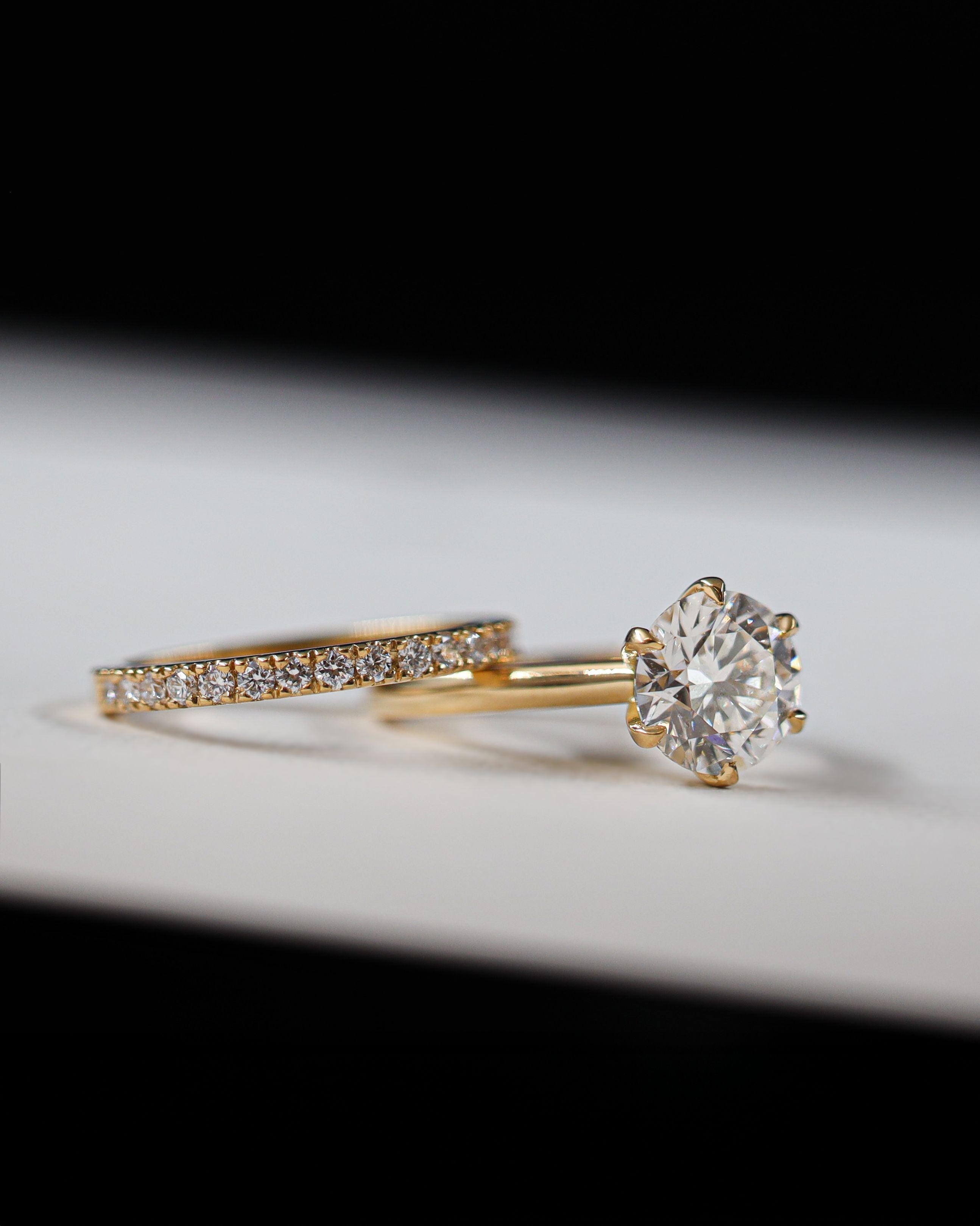 round diamiond yellow gold engagement ring with matching diamond wedding band